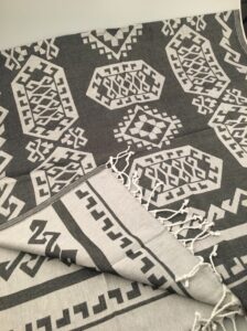 Custom jacquard woven hamam towel pestemal with detailed pattern and hand-knotted tassels